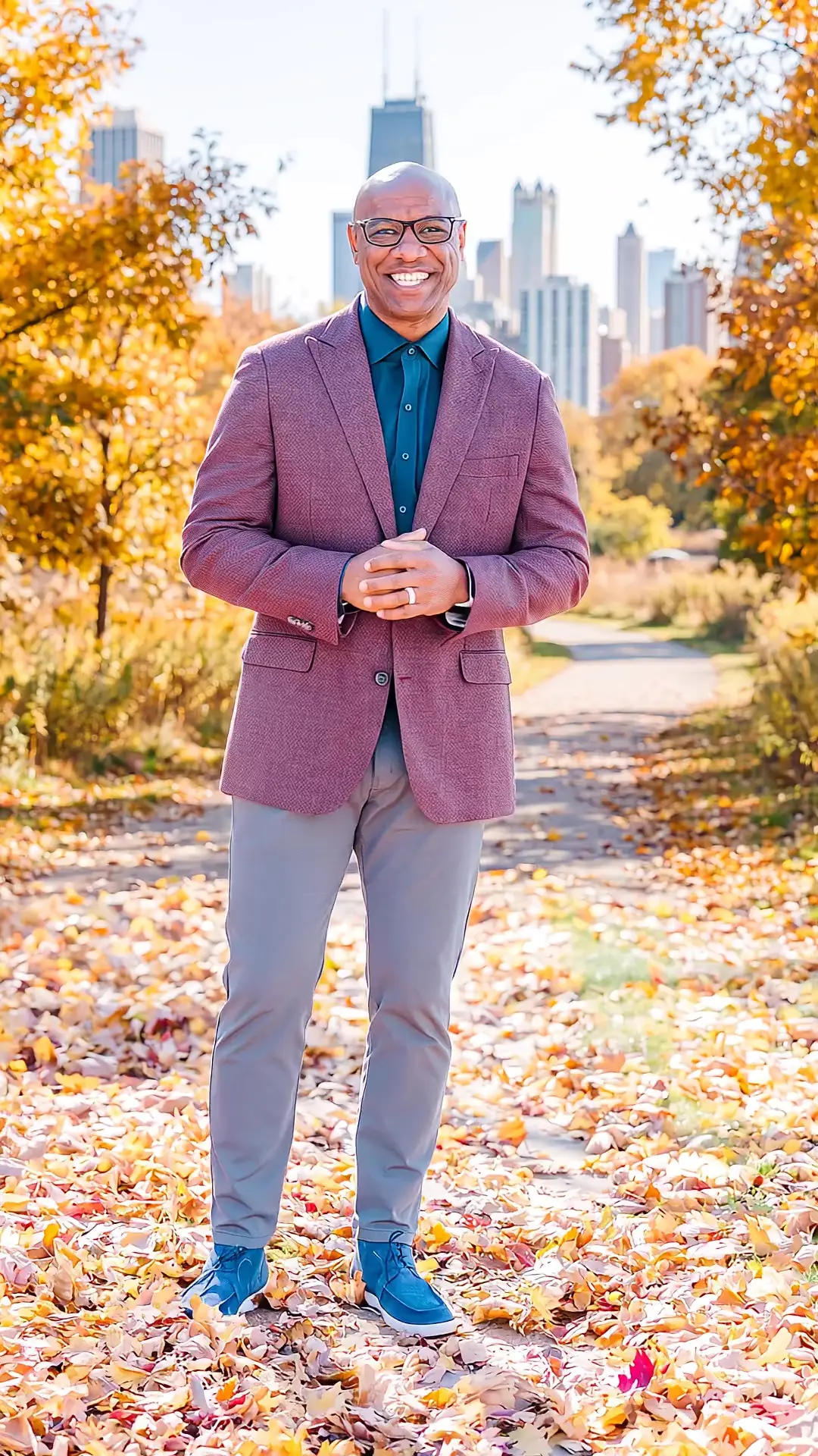 Jarrett Payton walks through Lincoln Park in autumn, the Chicago skyline behind